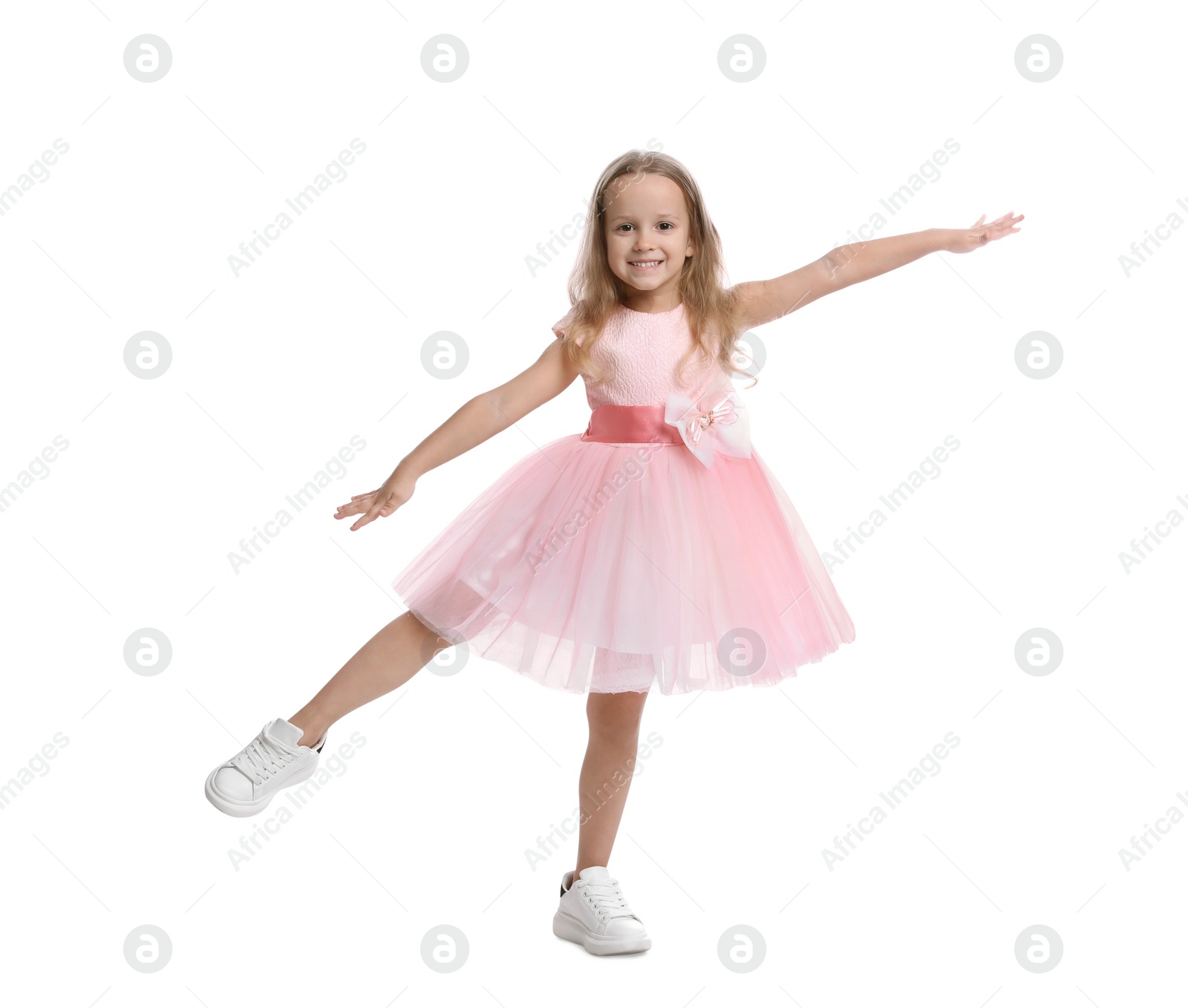 Photo of Cute little girl in beautiful dress dancing on white background