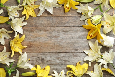 Photo of Flat lay composition with lily flowers on wooden background
