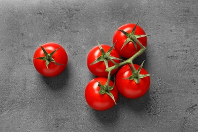 Photo of Fresh cherry tomatoes on stone background, flat lay