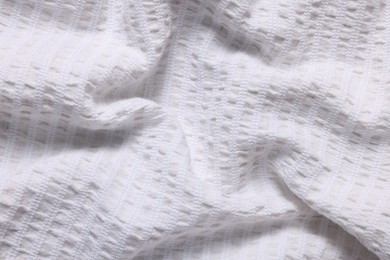 Photo of Texture of light crumpled fabric as background, closeup