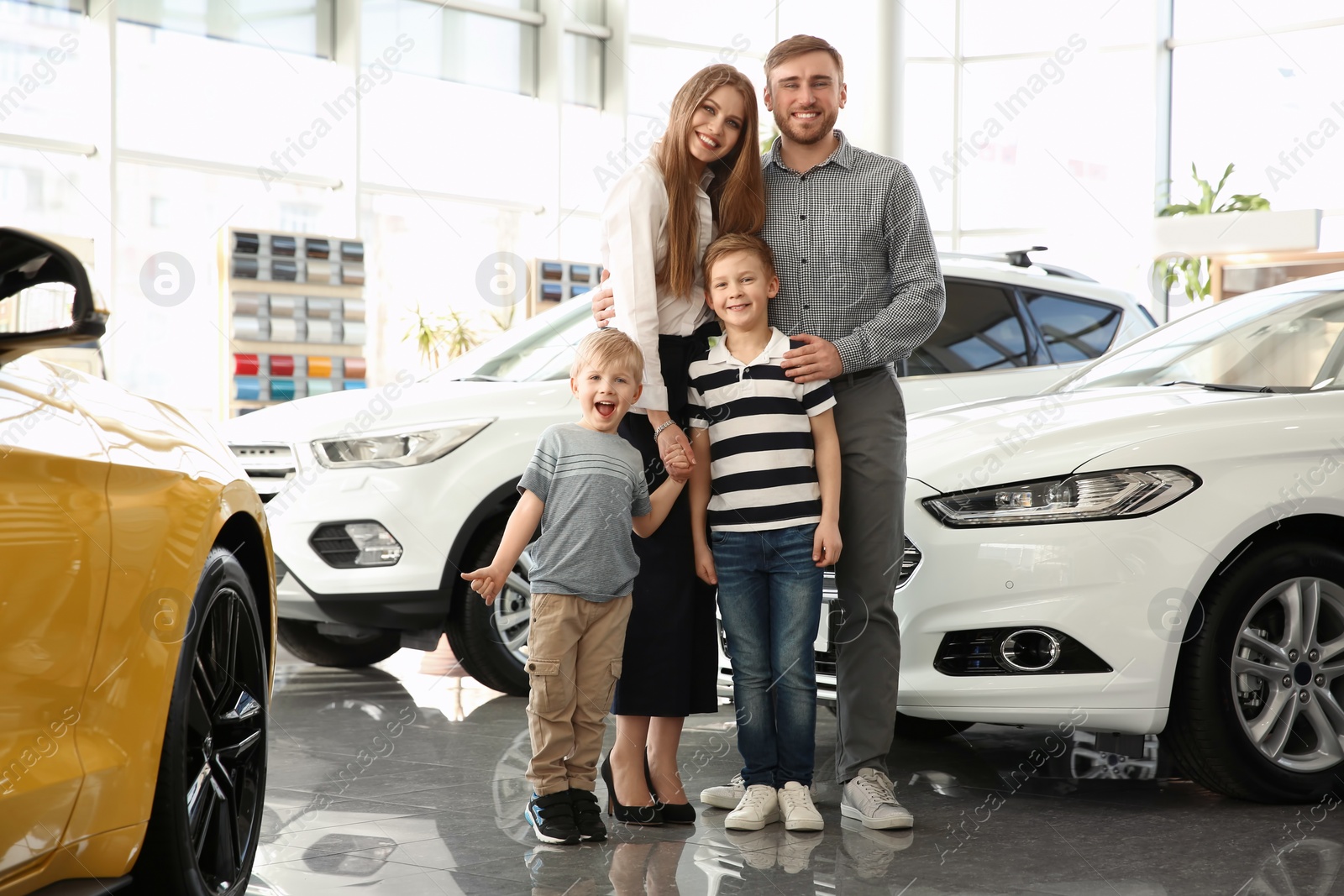 Photo of Young family in car salon