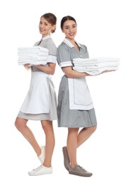 Photo of Full length portrait of chambermaids with towels on white background