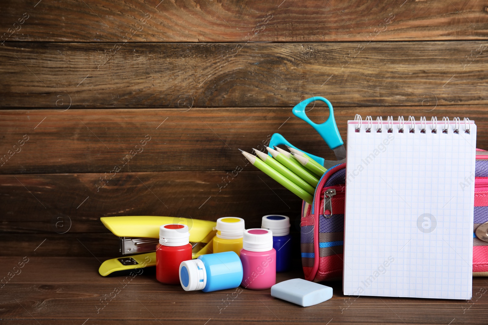 Photo of Different stationery on wooden table. Back to school