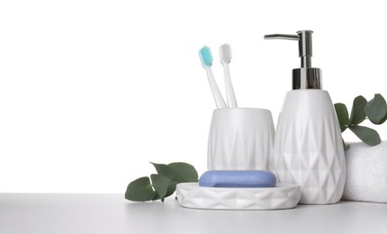 Photo of Bath accessories. Different personal care products and eucalyptus branches on table against white background. Space for text