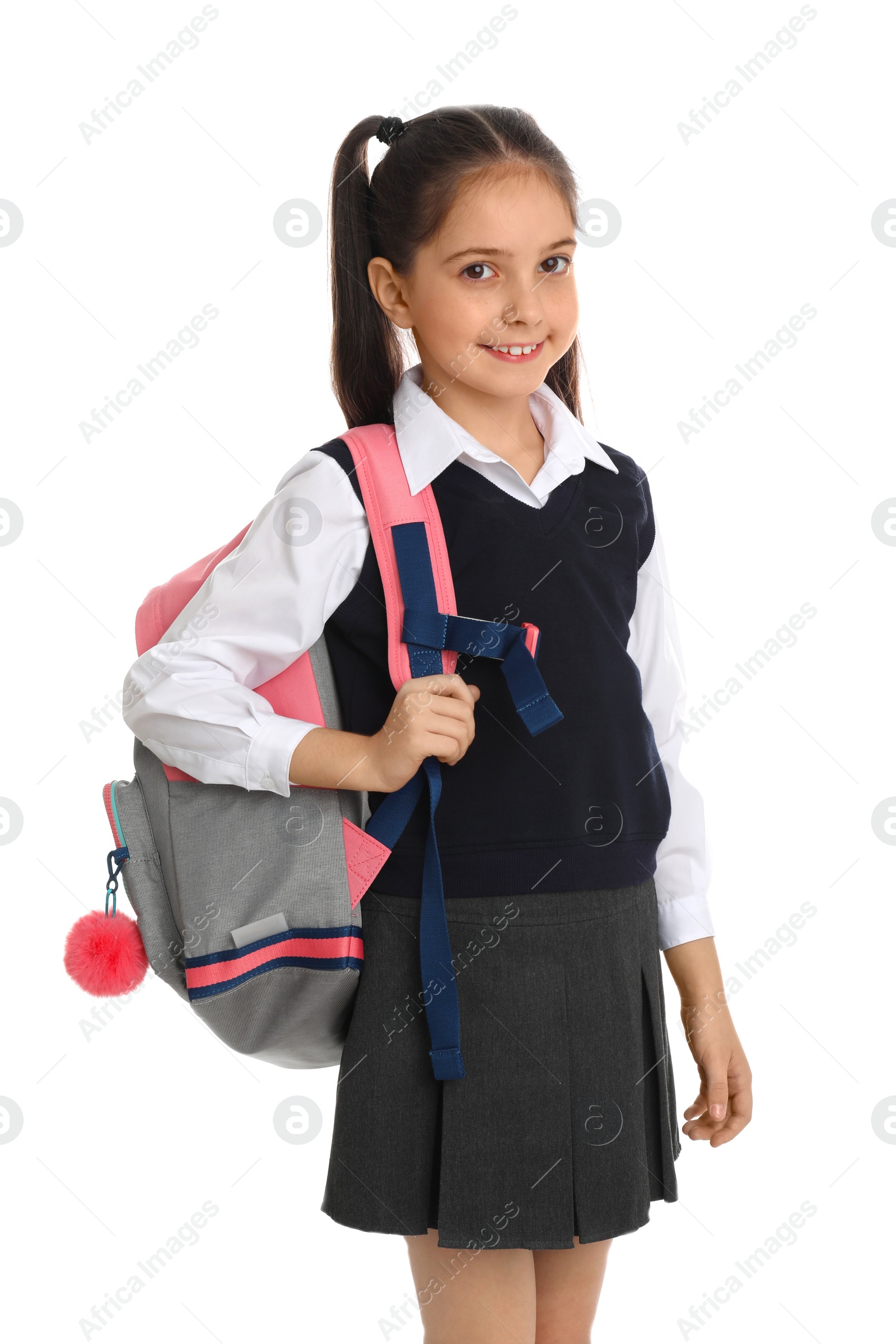 Photo of Little girl in school uniform with backpack on white background