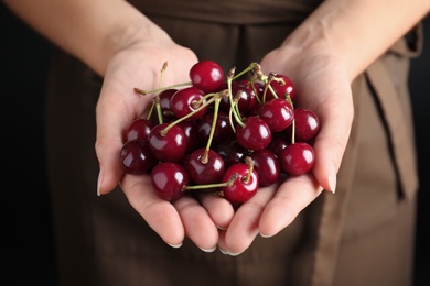 Woman holding sweet juicy cherries, closeup view