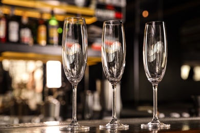 Empty clean champagne glasses on counter in bar