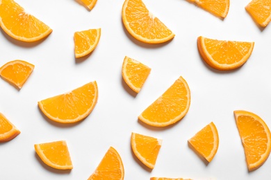 Composition with orange slices on white background, top view