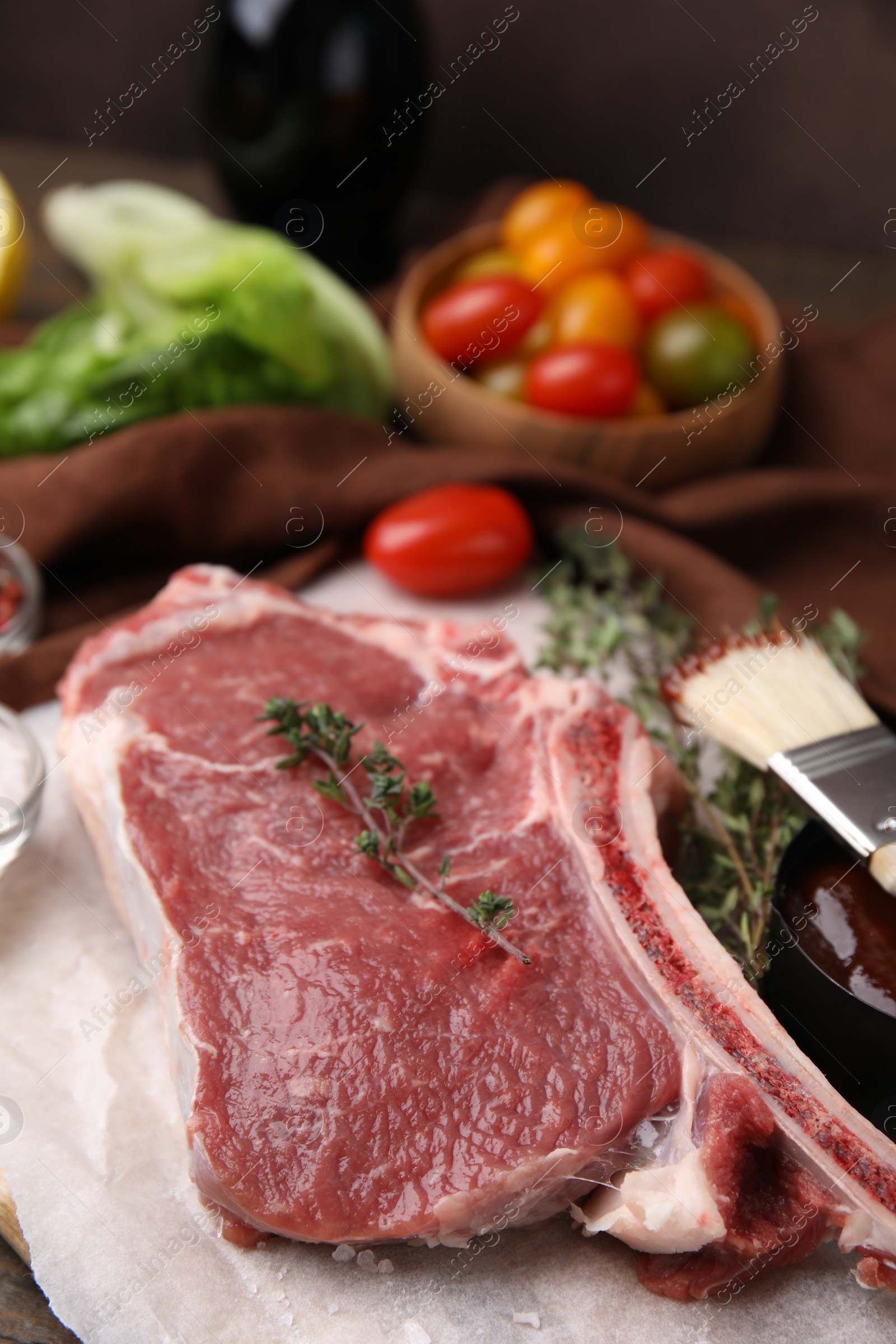 Photo of Raw meat and thyme on table, closeup