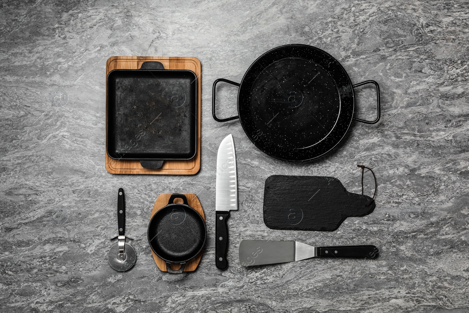 Photo of Set of cooking utensils on grey table, flat lay