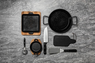 Photo of Set of cooking utensils on grey table, flat lay