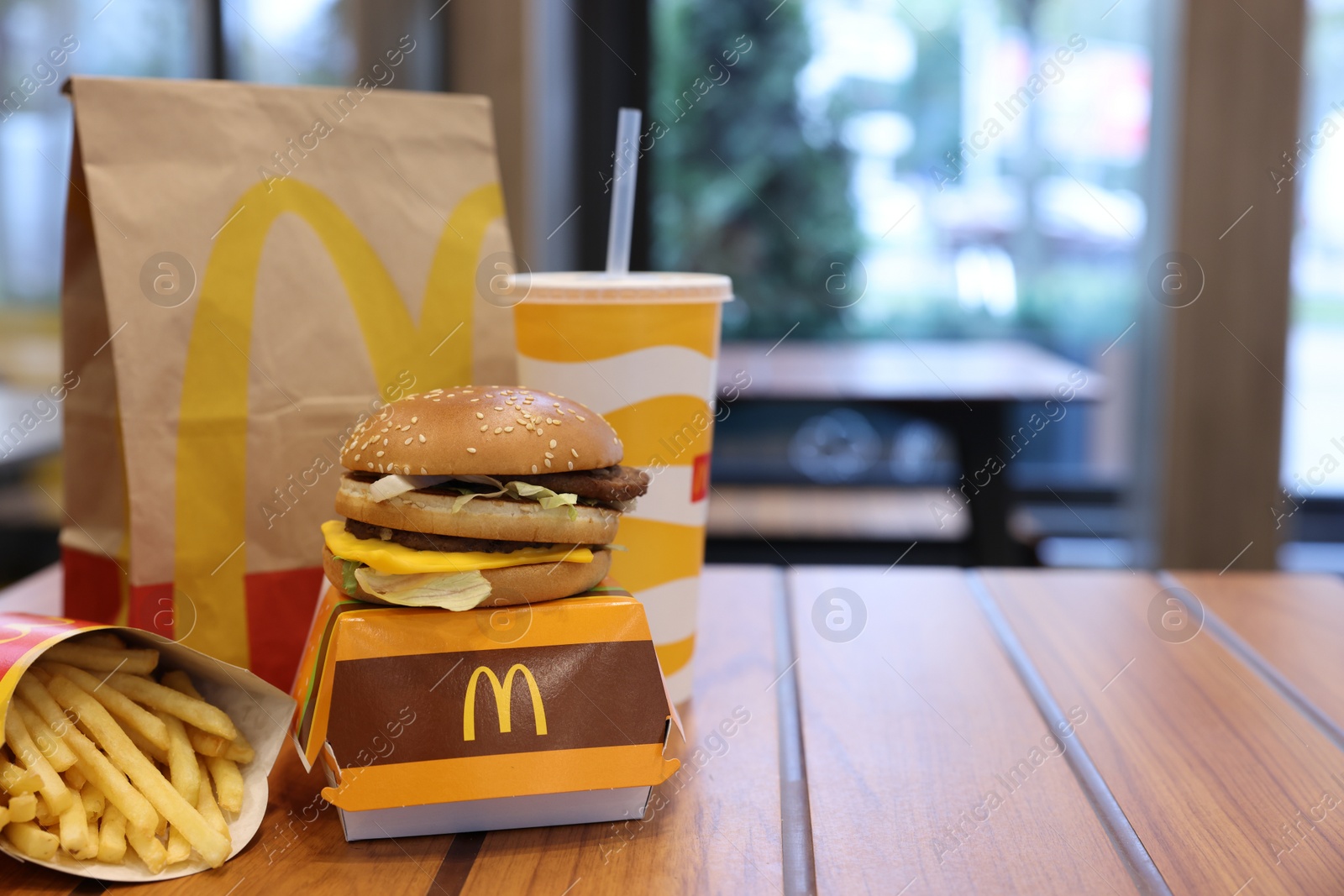 Photo of Lviv, Ukraine - October 9, 2023: McDonald's menu on wooden table in restaurant, space for text
