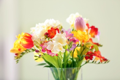 Photo of Beautiful bouquet of freesia flowers on blurred background