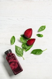 Photo of Flat lay composition with beet smoothie on white wooden background with space for text