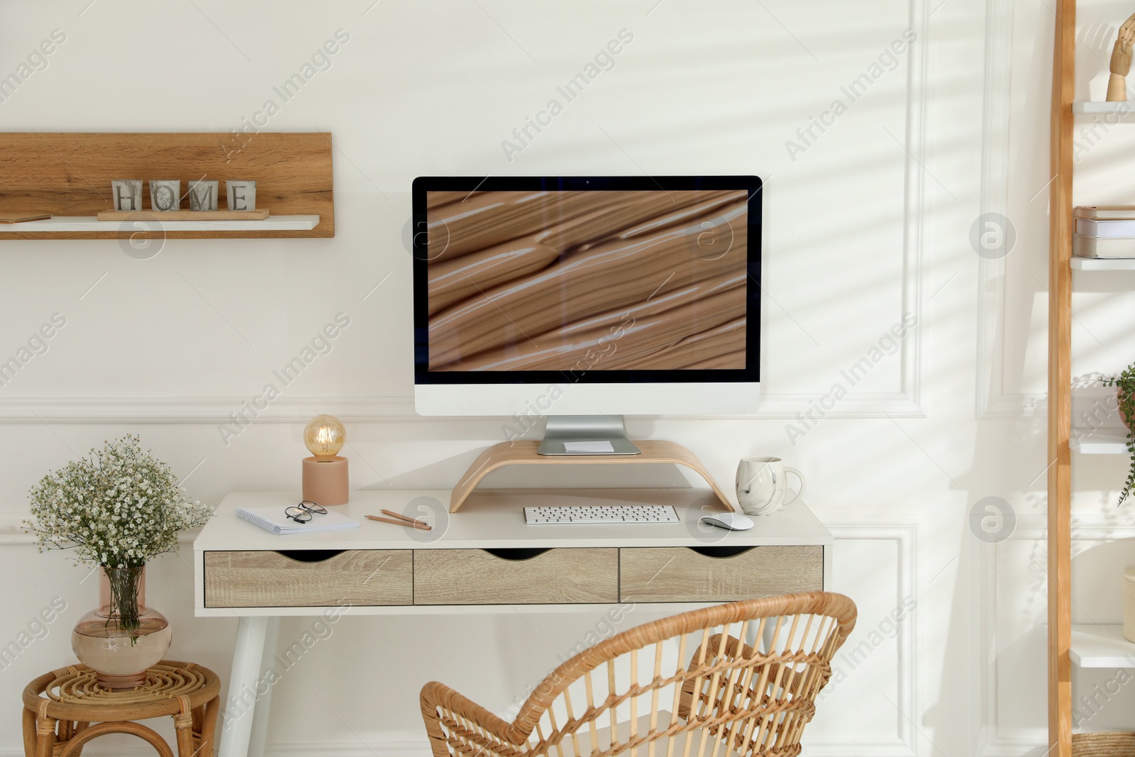 Photo of Comfortable workplace with modern computer and lamp in room. Interior design
