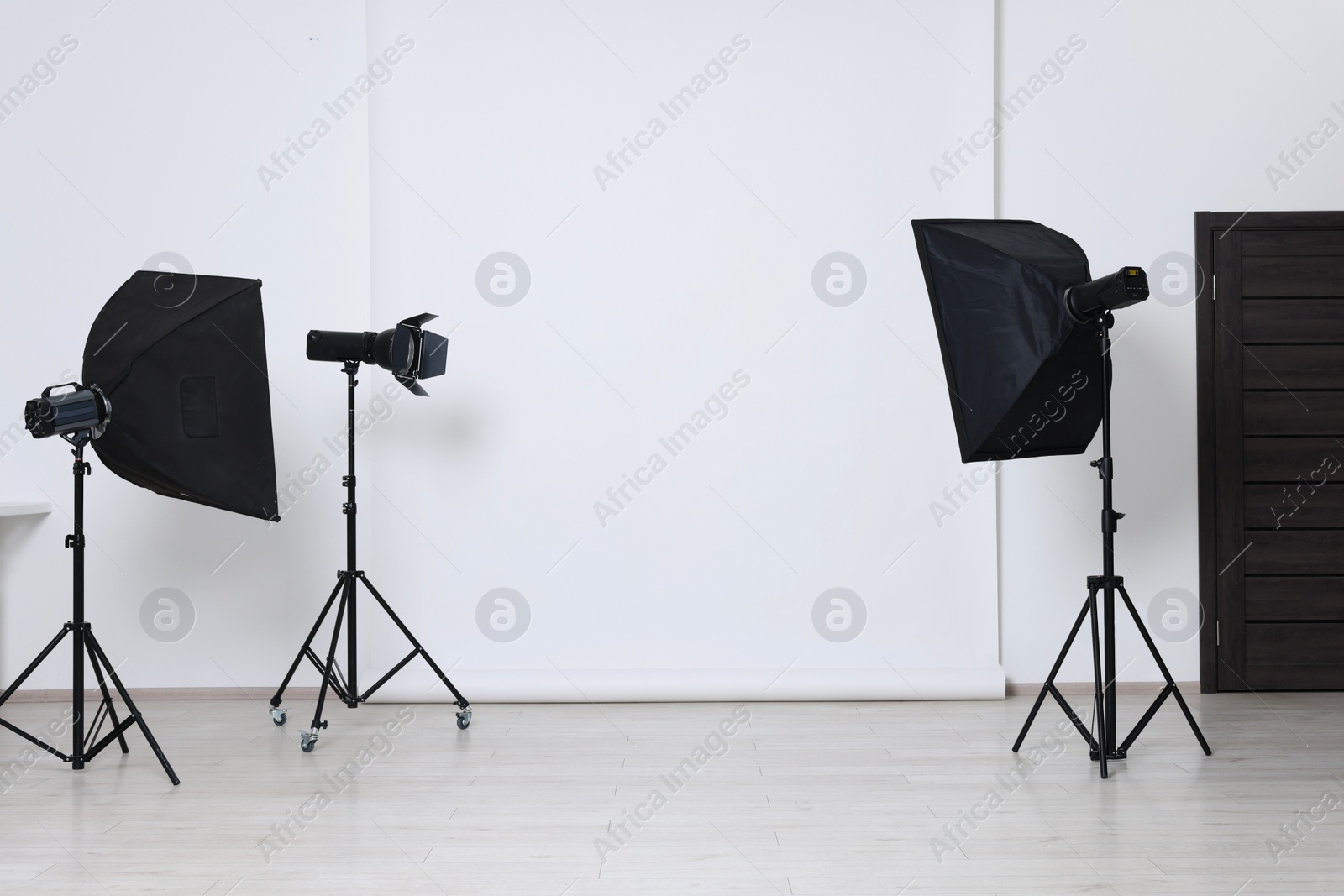 Photo of White photo background and professional lighting equipment in studio