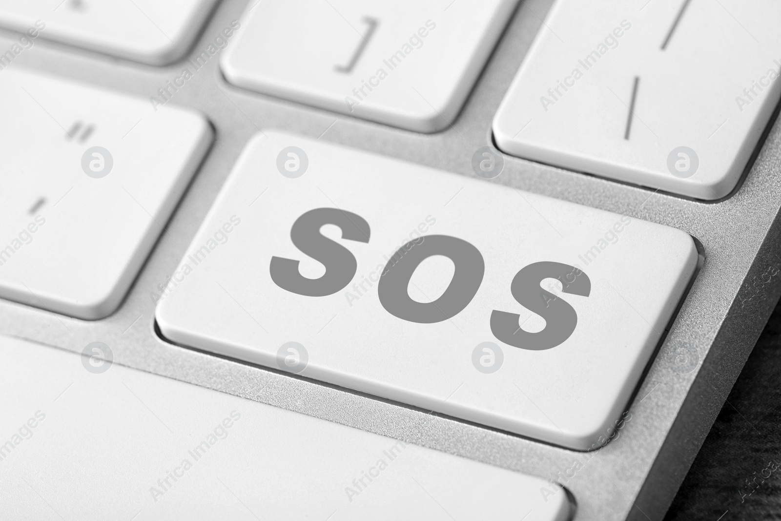 Image of Button with word SOS on computer keyboard, closeup. Rescue concept