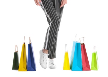 Young woman with shopping bags on white background, closeup