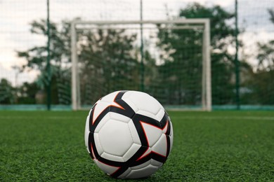 Photo of New soccer ball on green football field