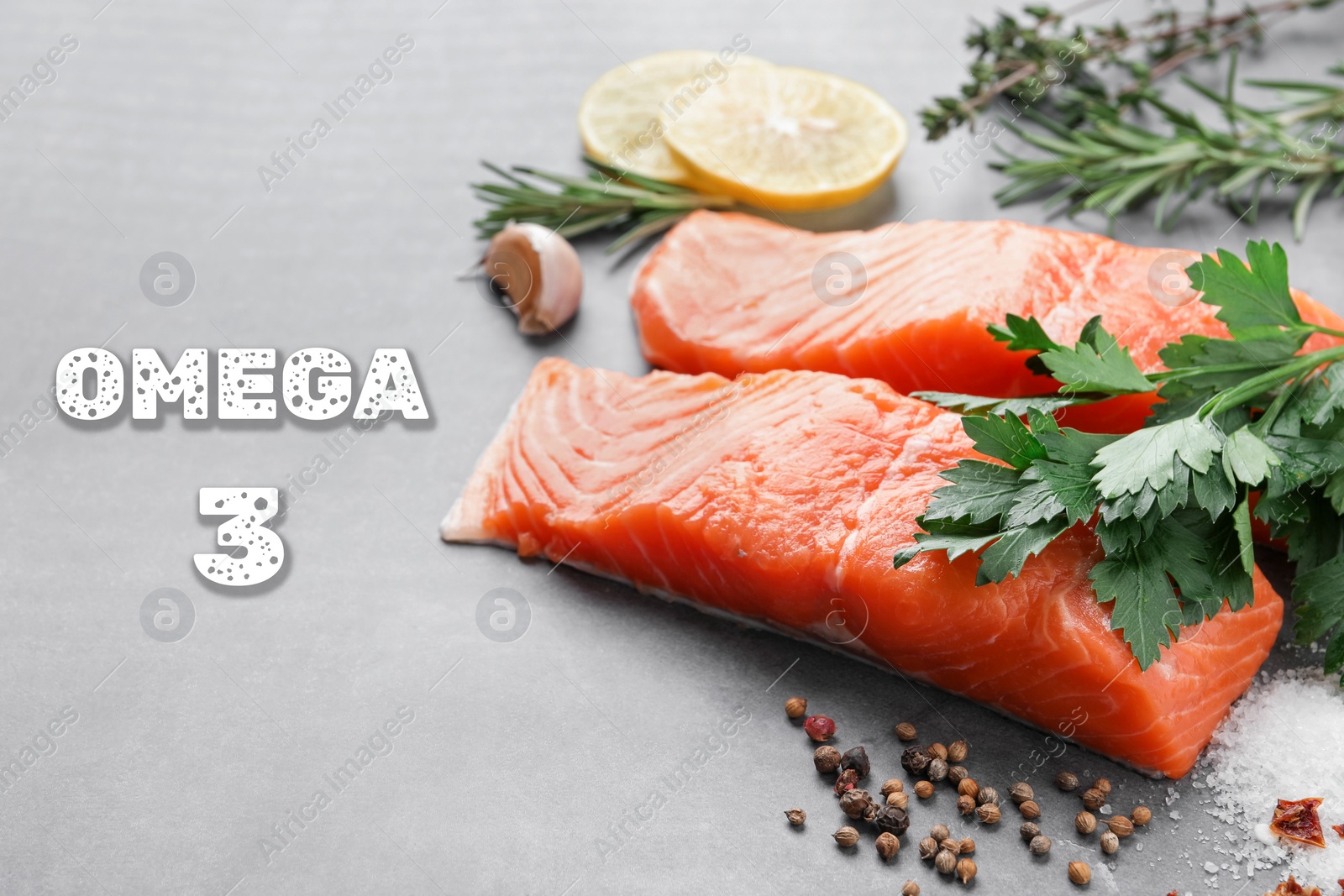 Image of Omega 3. Fresh cut salmon, herbs and spices on grey table, closeup