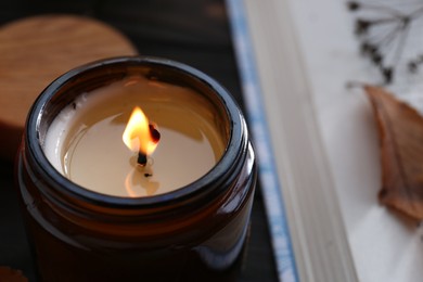 Photo of Beautiful burning candle, closeup with space for text. Autumn atmosphere