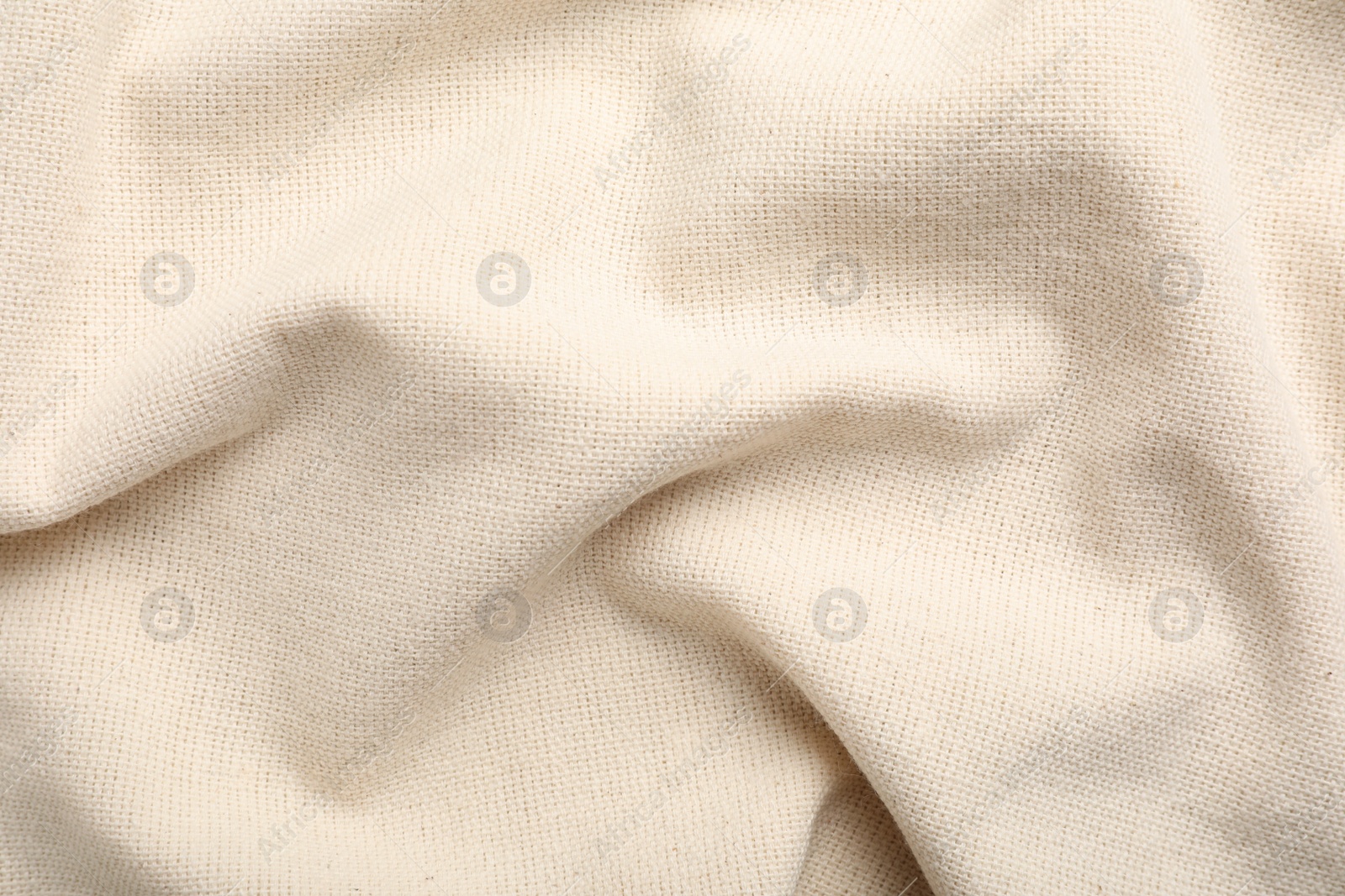 Photo of Beige hemp cloth as background, top view. Natural fabric
