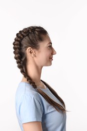 Woman with braided hair on light background
