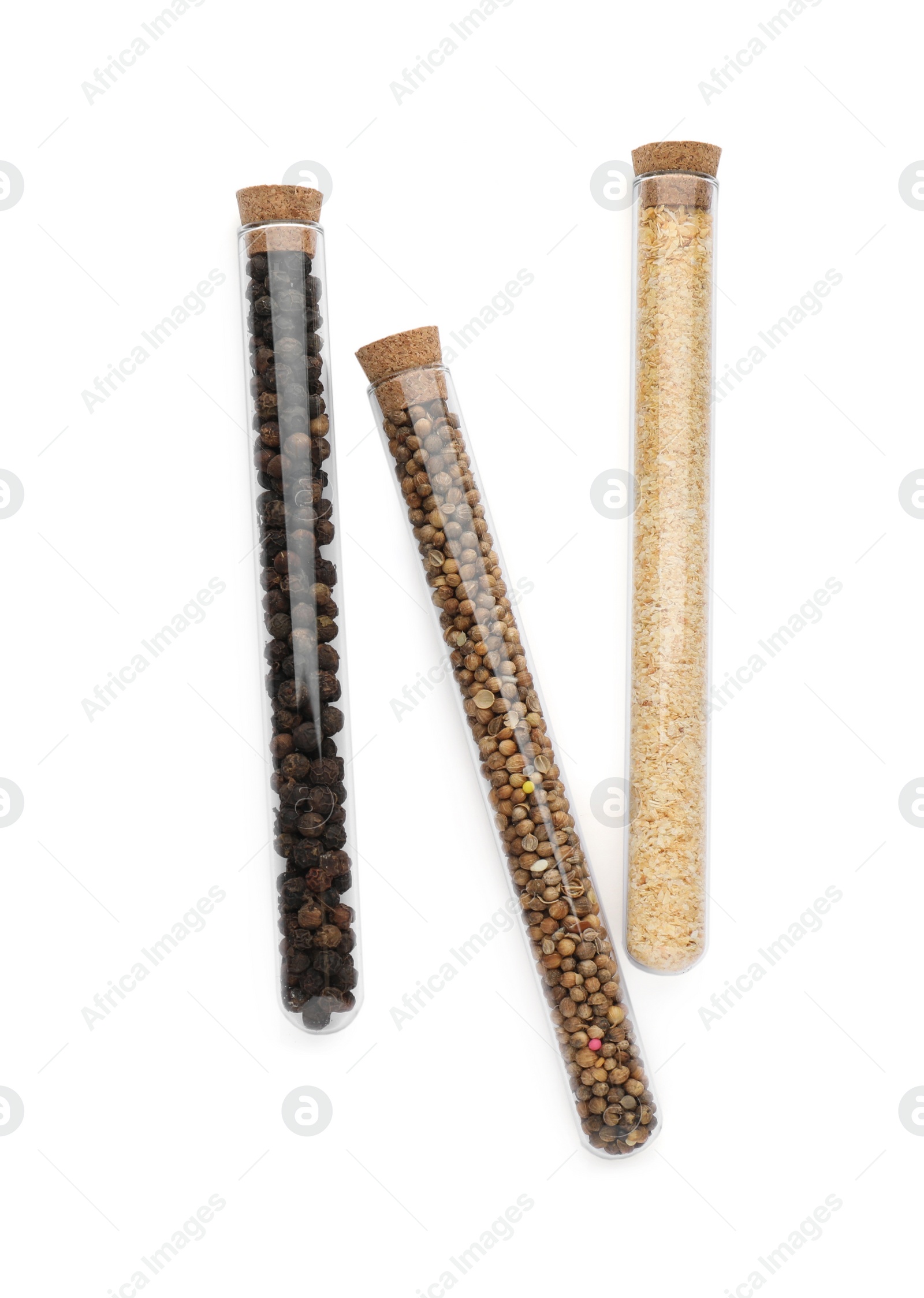 Photo of Glass tubes with coriander seeds, garlic powder and peppercorns on white background, top view