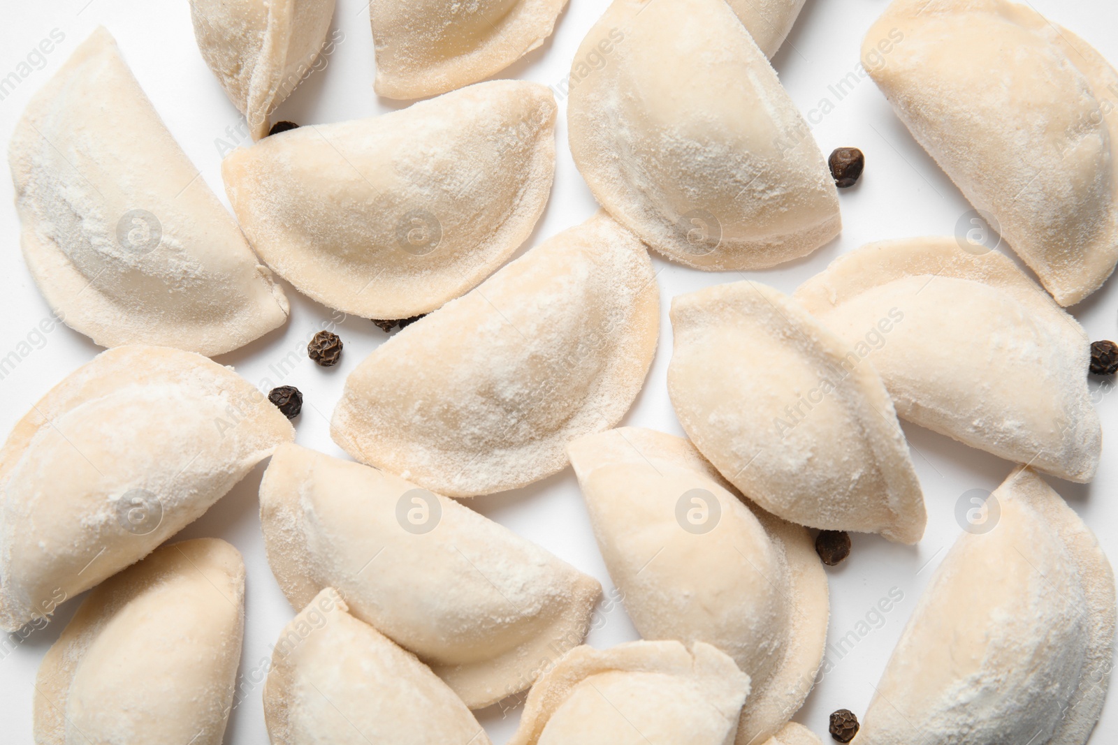 Photo of Raw dumplings on white background, top view. Home cooking