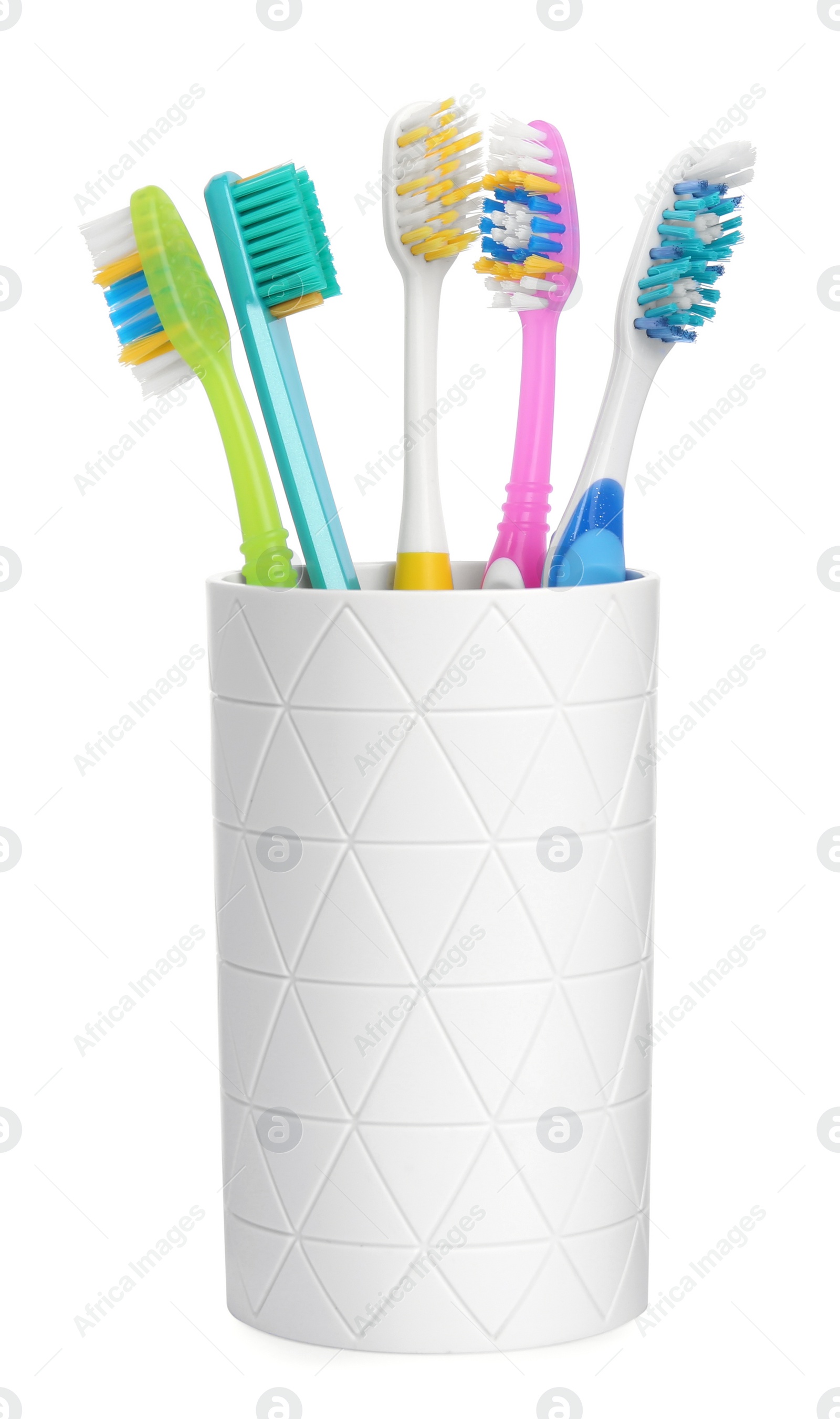 Photo of Different toothbrushes in holder isolated on white