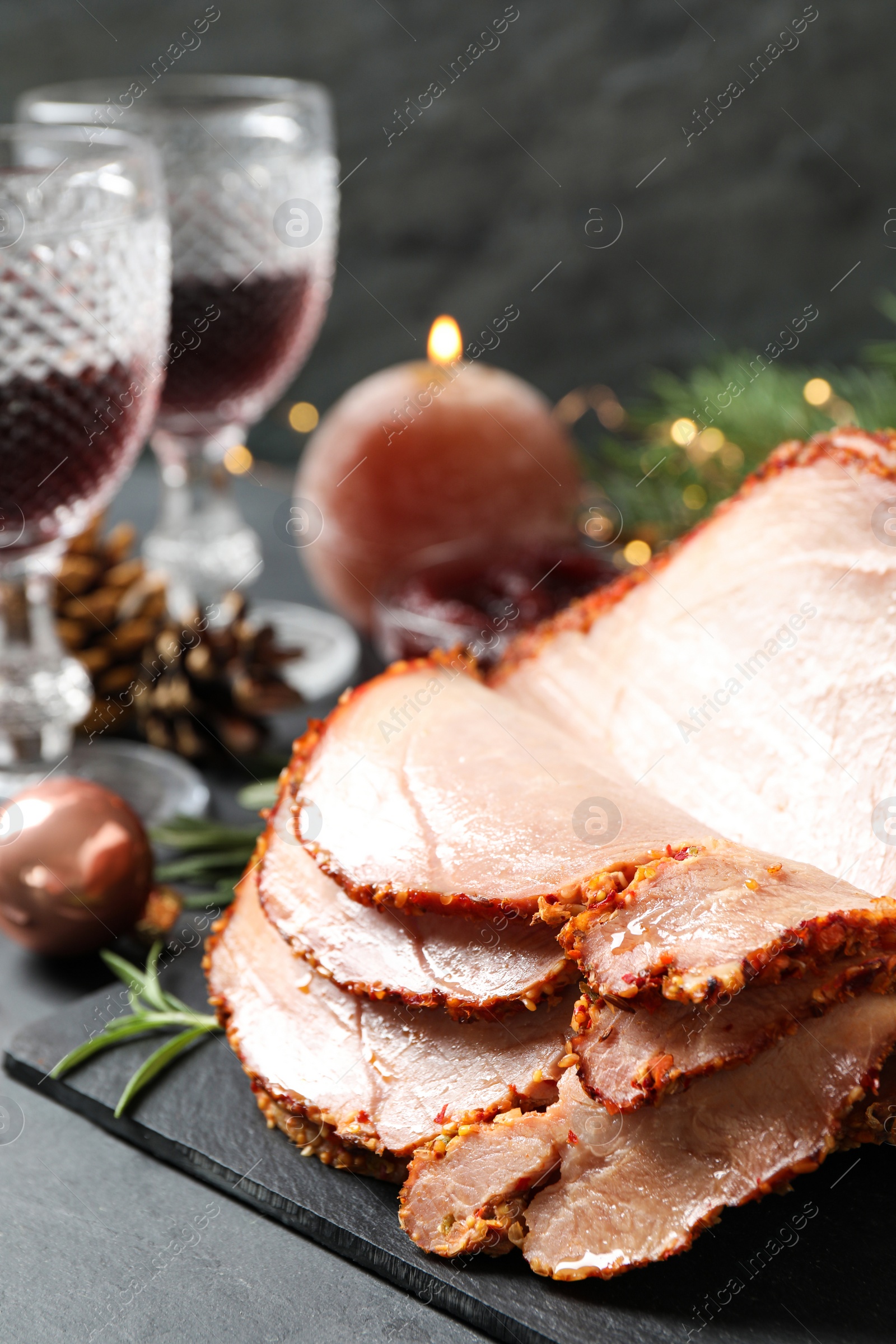 Photo of Delicious Christmas ham served on dark table, closeup
