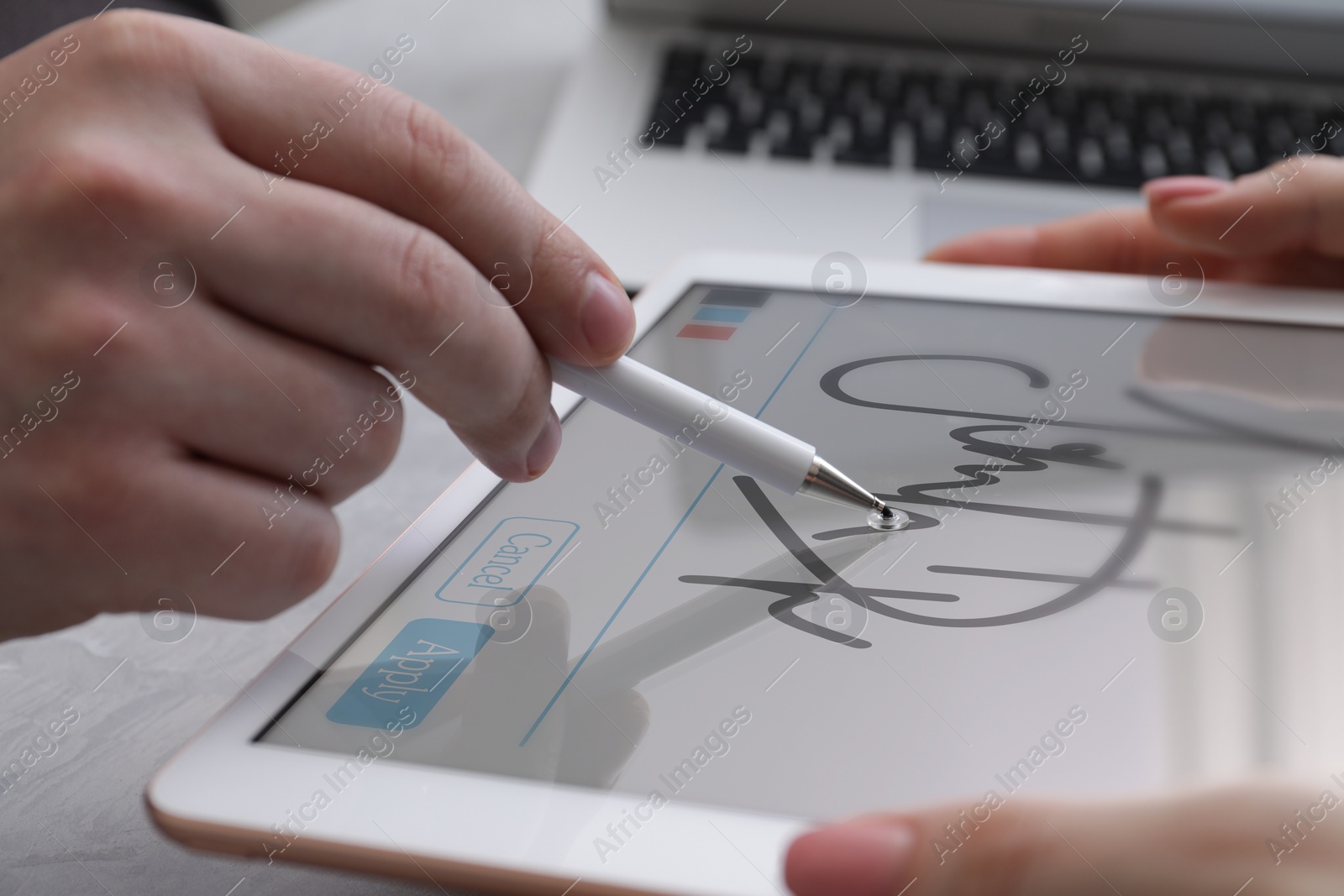 Image of Electronic signature. Man using stylus and tablet at table, closeup