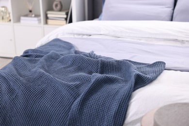 Soft blue plaid on bed in room