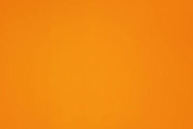Photo of Beautiful orange surface of wall as background, closeup
