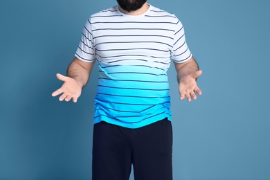 Overweight man on color background