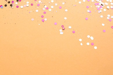 Shiny bright pink glitter on beige background. Space for text