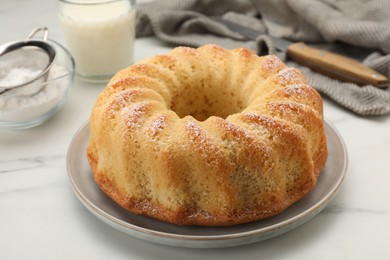 Photo of Delicious freshly baked sponge cake on white table, closeup