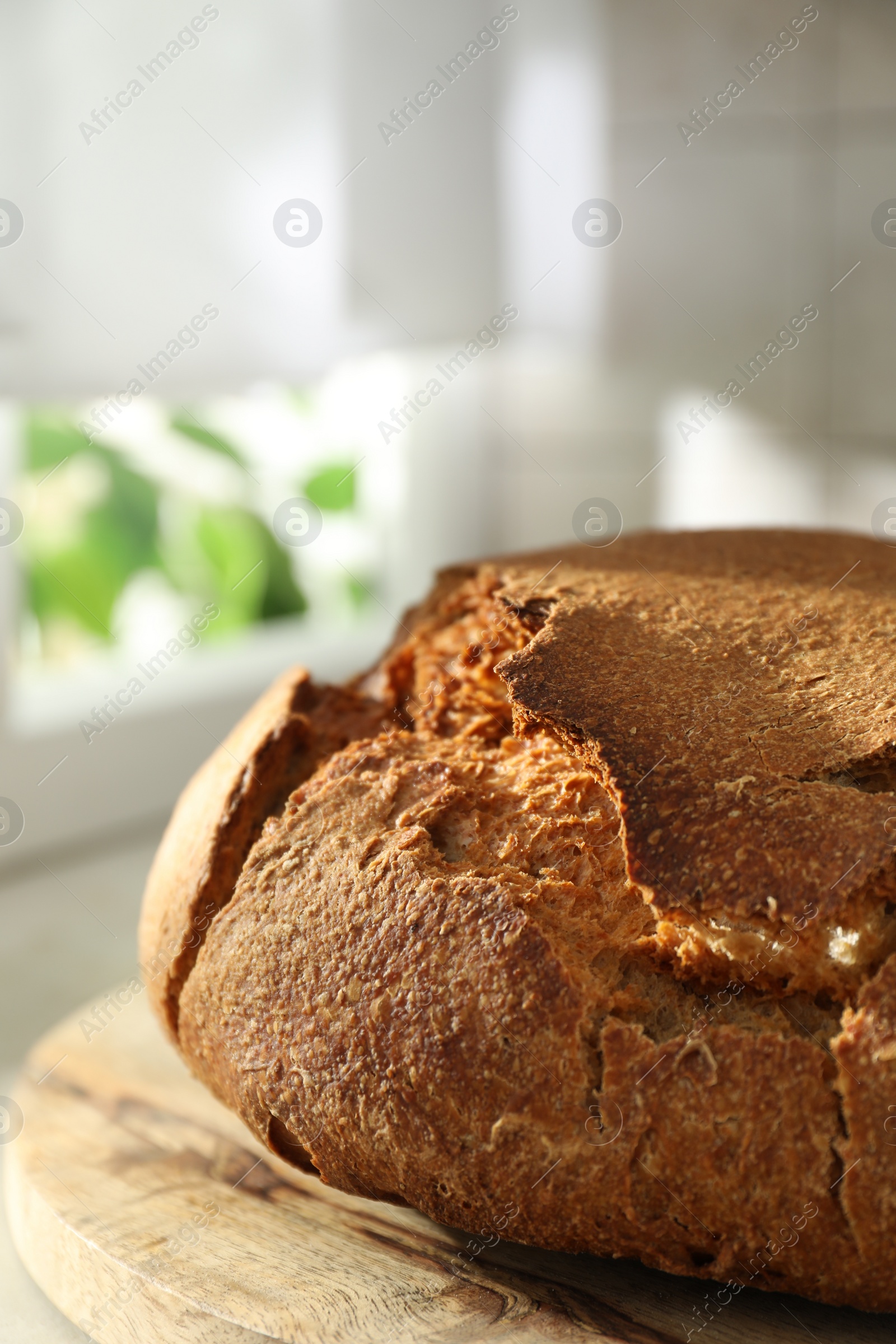 Photo of Freshly baked sourdough bread on light table, closeup