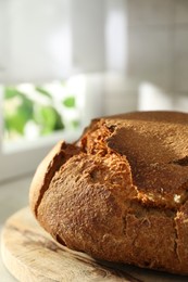 Freshly baked sourdough bread on light table, closeup