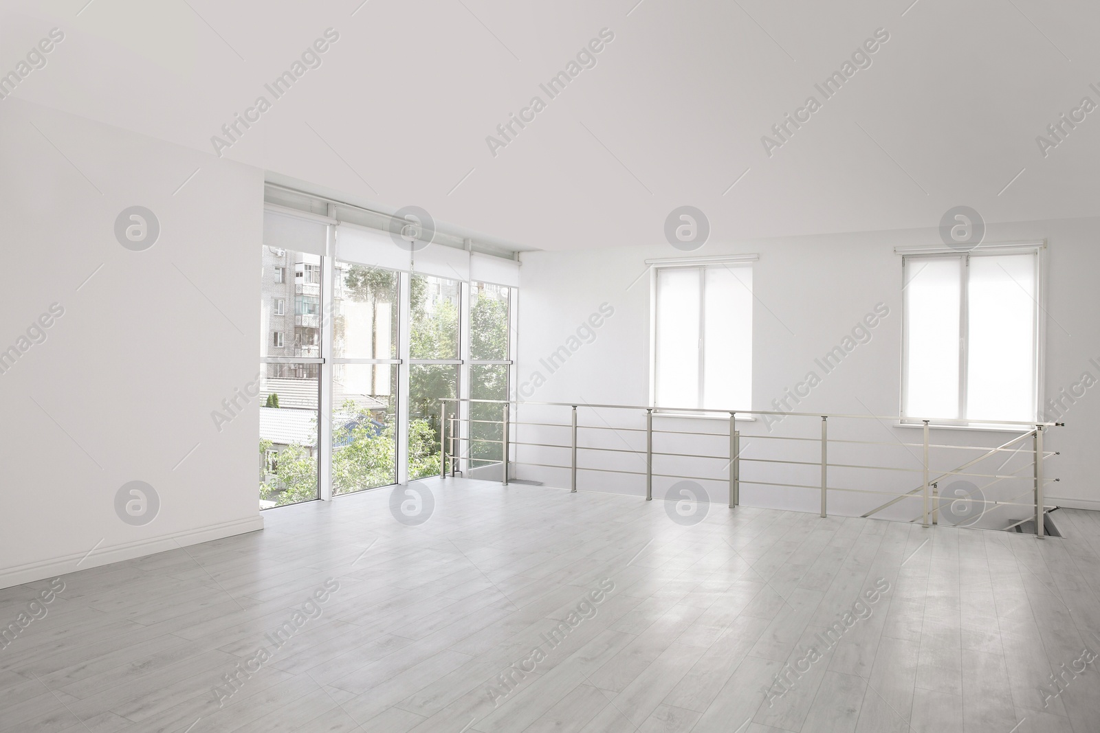 Photo of Empty room with windows and laminated floor