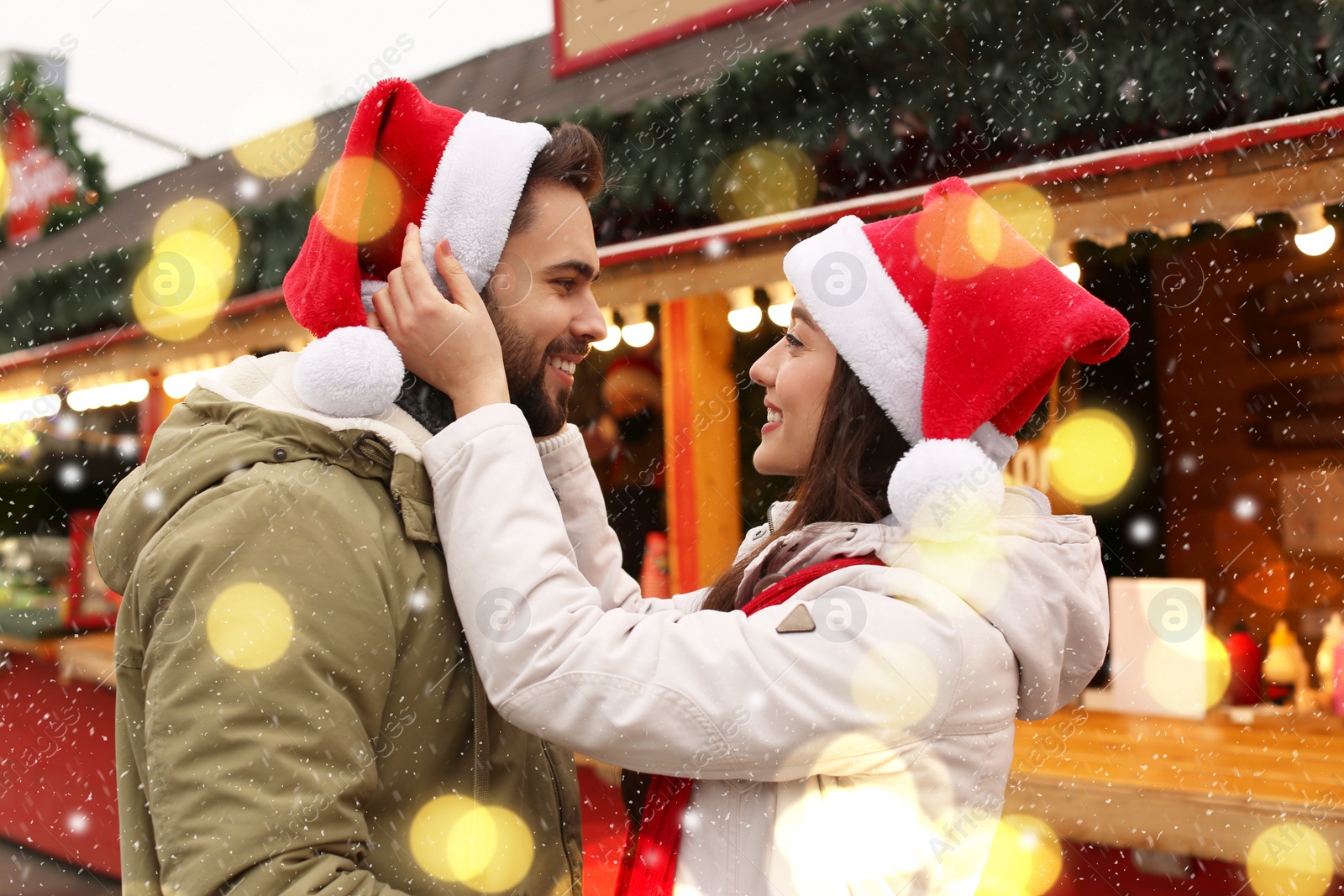 Image of Lovely couple spending time together at Christmas fair