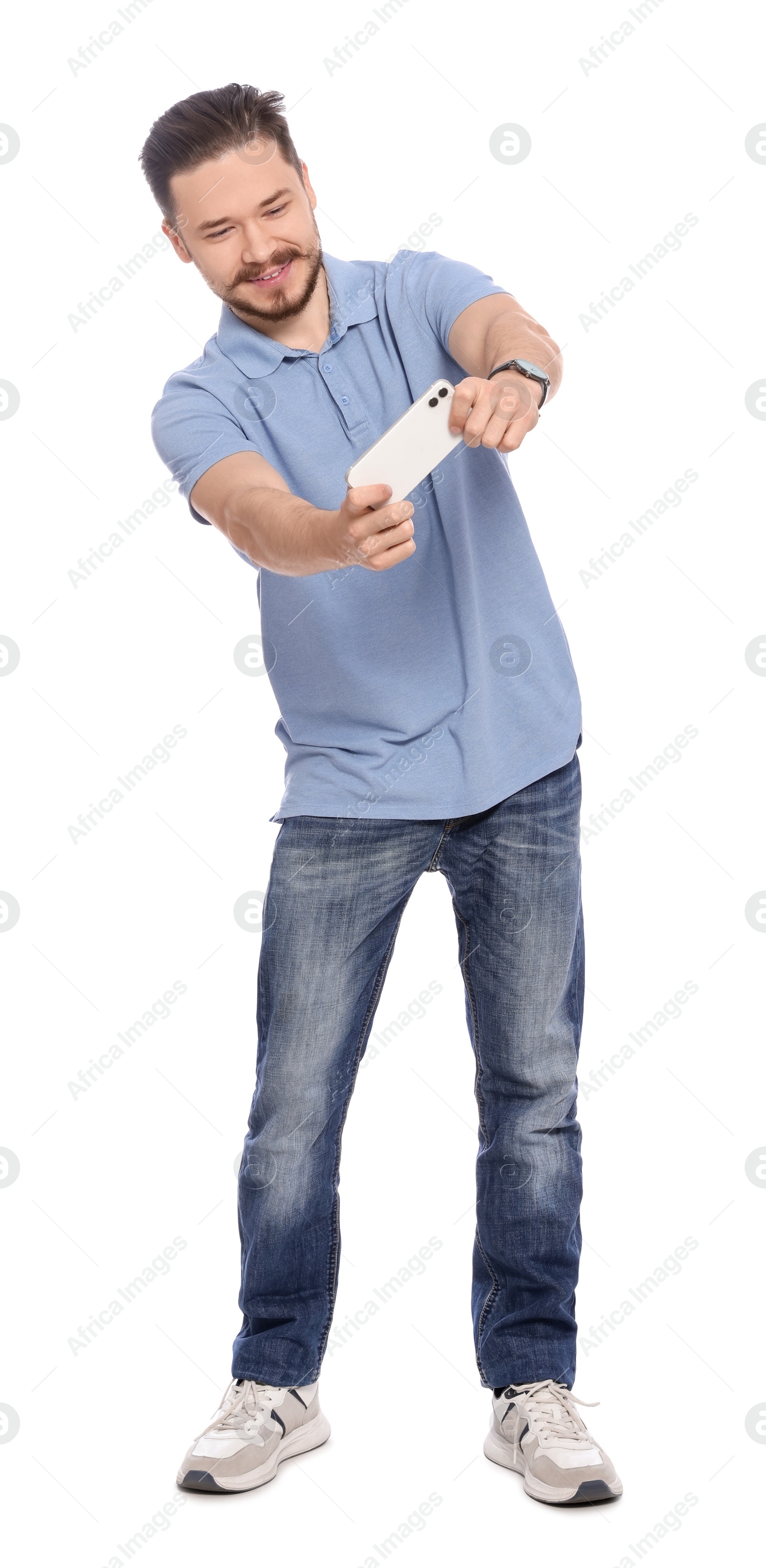 Photo of Happy man playing game on phone against white background