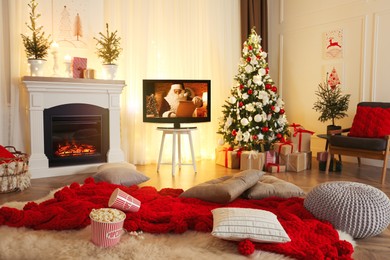 Stylish living room interior with TV set, Christmas tree and fireplace