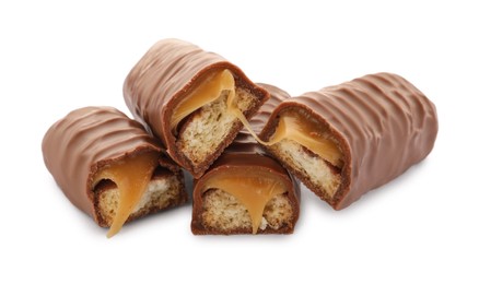 Photo of Pieces of chocolate bars with caramel on white background