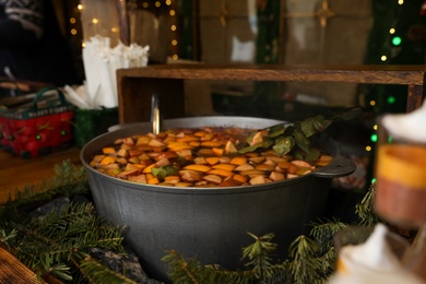 Big pot with mulled wine at Christmas fair stall