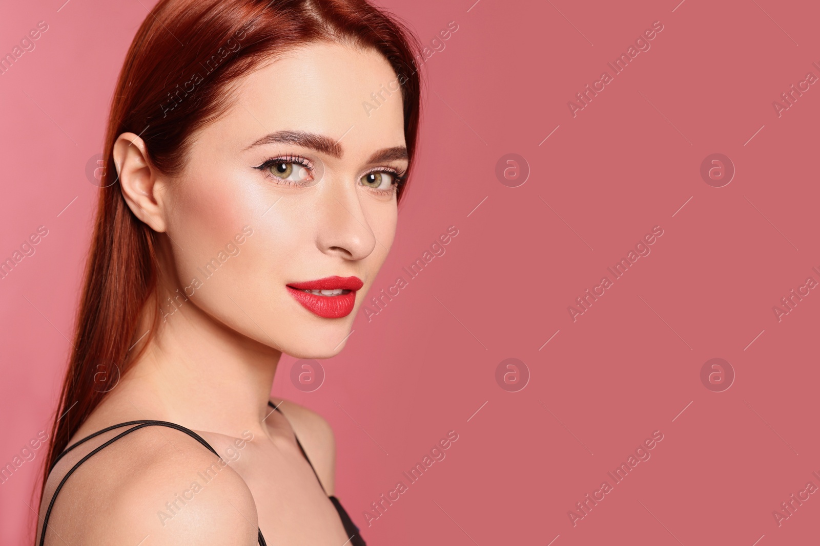 Photo of Beautiful woman with red dyed hair on pink background, space for text