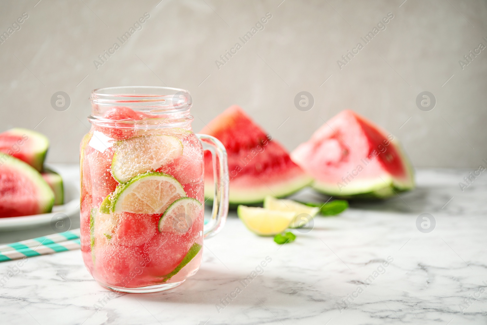 Photo of Tasty refreshing watermelon drink on marble table. Space for text