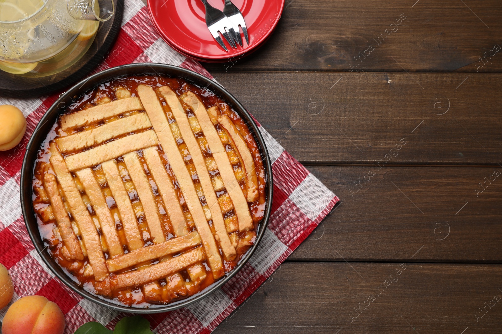Photo of Delicious apricot pie in baking dish on wooden table, flat lay. Space for text