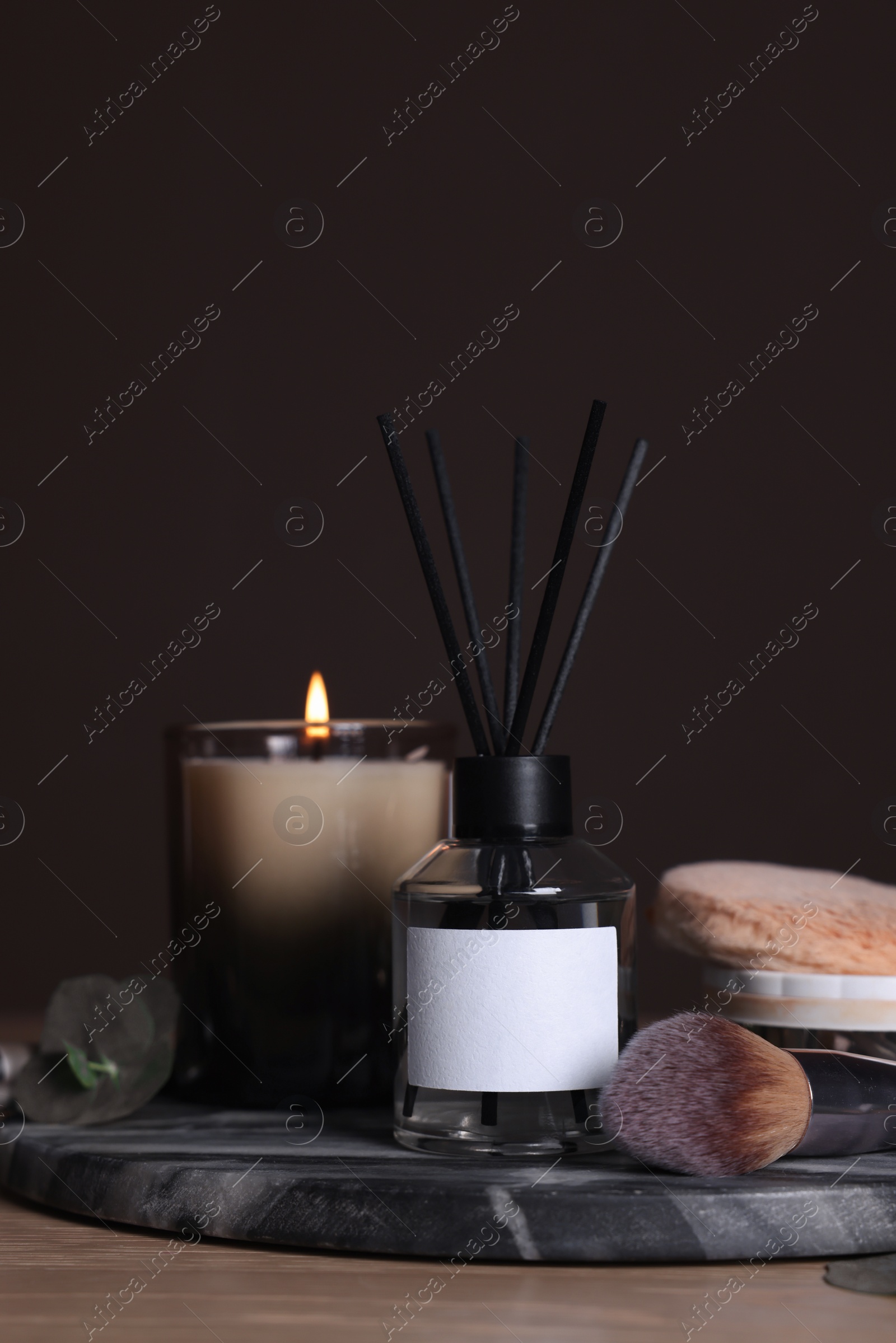 Photo of Composition with aromatic reed air freshener on wooden table