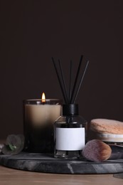 Photo of Composition with aromatic reed air freshener on wooden table